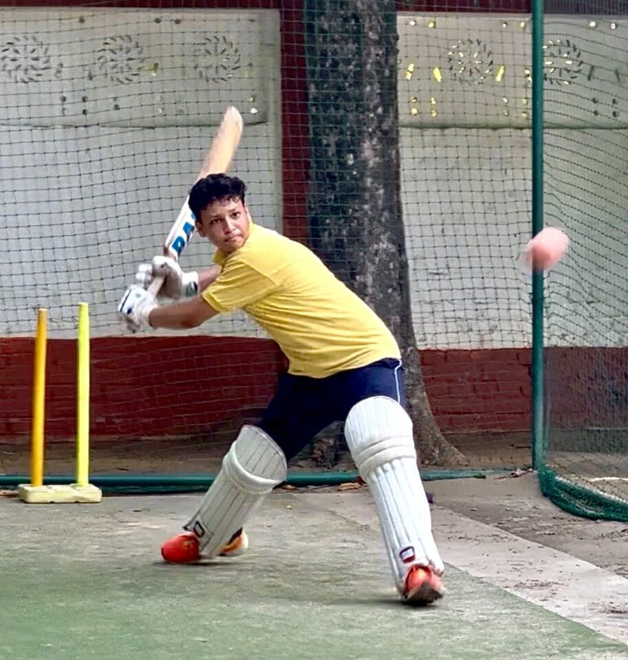 Child batting during cricket coaching
